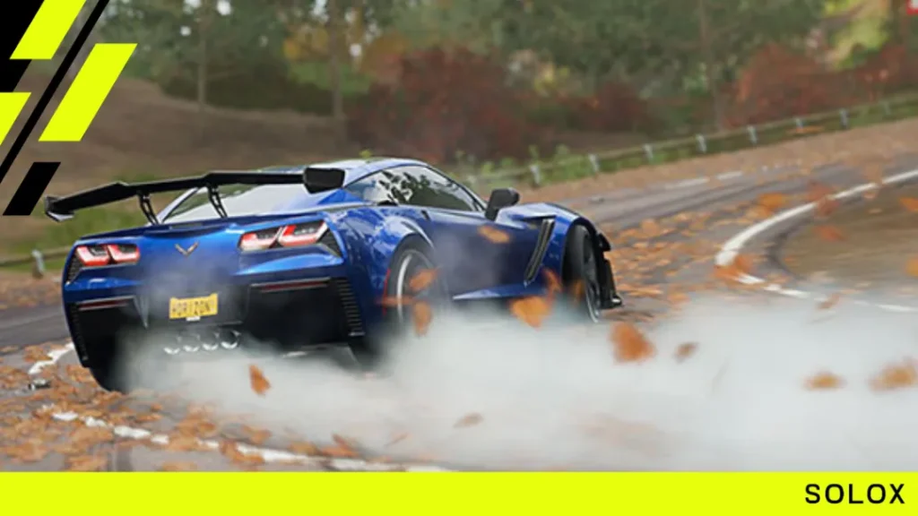 A blue Chevrolet Corvette drifting through autumn leaves in Forza Horizon 4