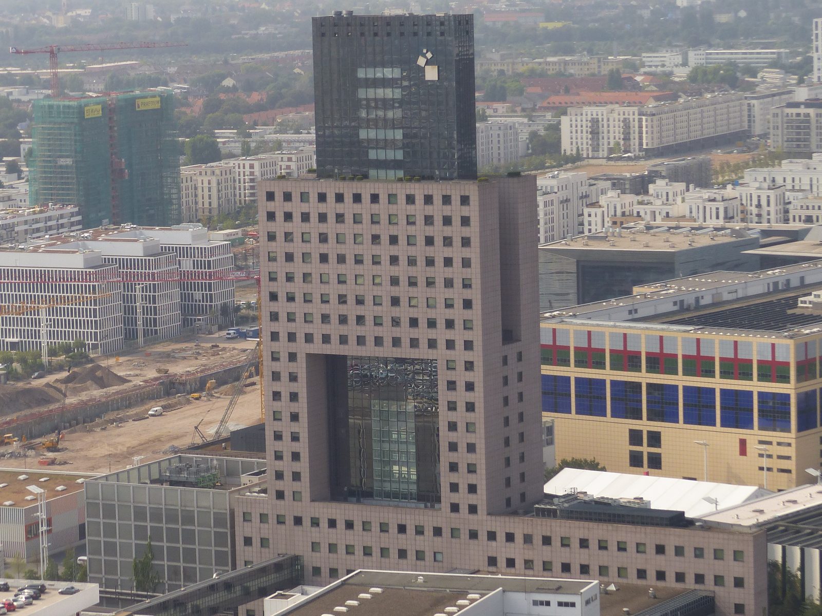 The Torhaus tower at Messe Frankfurt seen from above, with exhibition halls in front of it