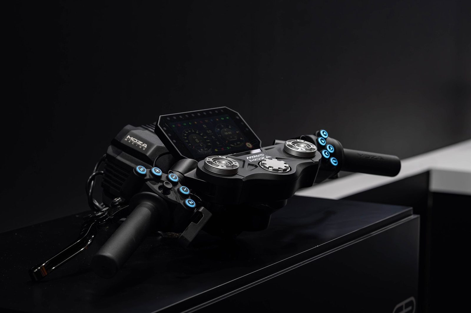 MOZA MotoGP handlebar mounted on a MOZA direct drive wheel base with a digital dashboard, blue backlit buttons and levers