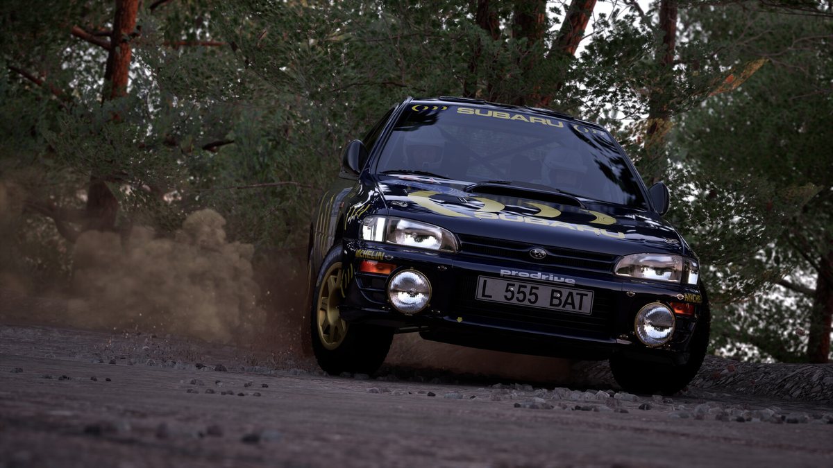 A blue Subaru Impreza Group A rally car kicks up dust on a forest stage in Assetto Corsa Rally