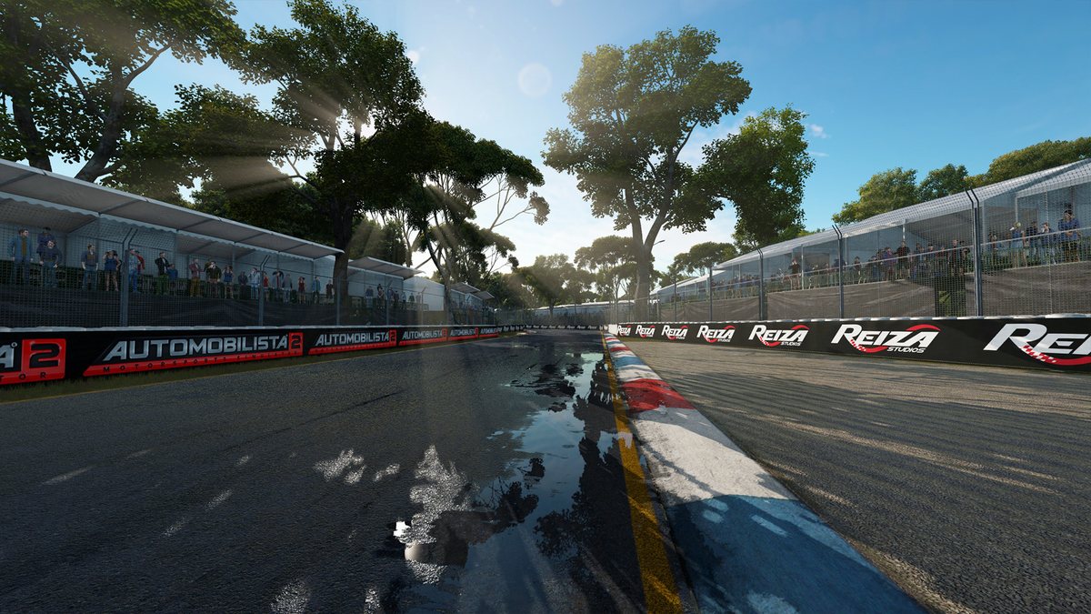 A wet track surface reflecting trees and trackside boards in Automobilista 2