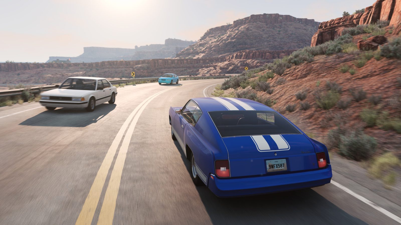 A white sedan and a blue muscle car with white stripes on a desert canyon road in BeamNG.drive