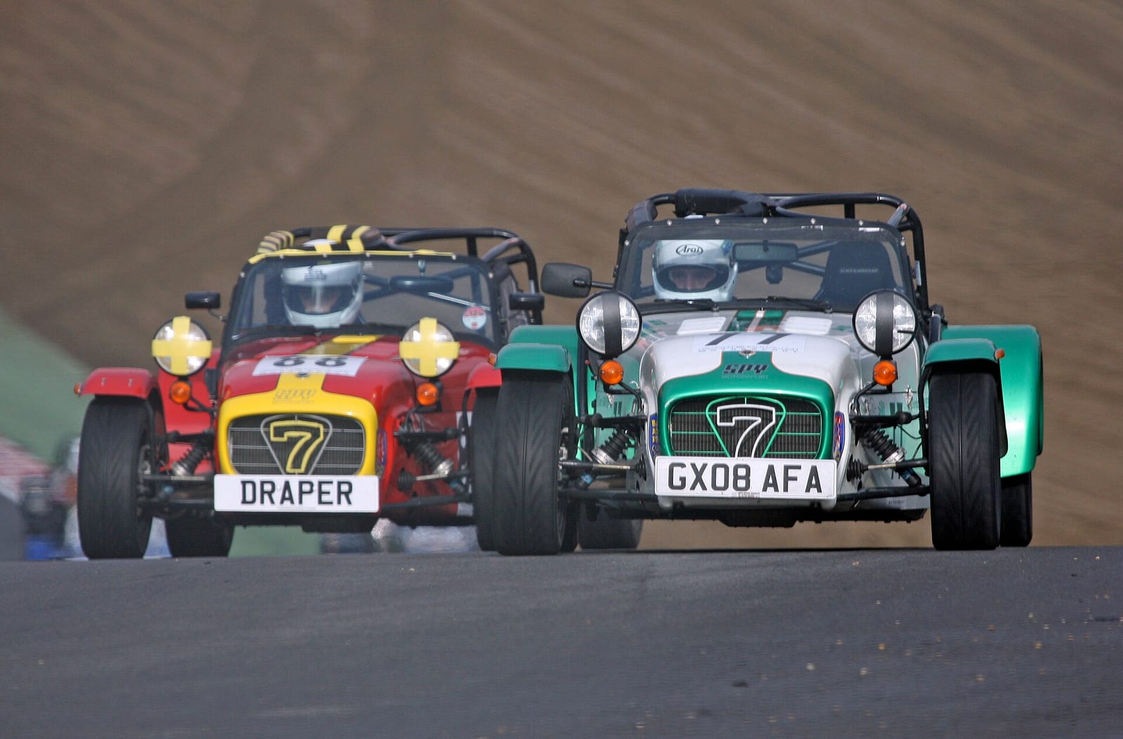 Two Caterham Academy cars racing side by side