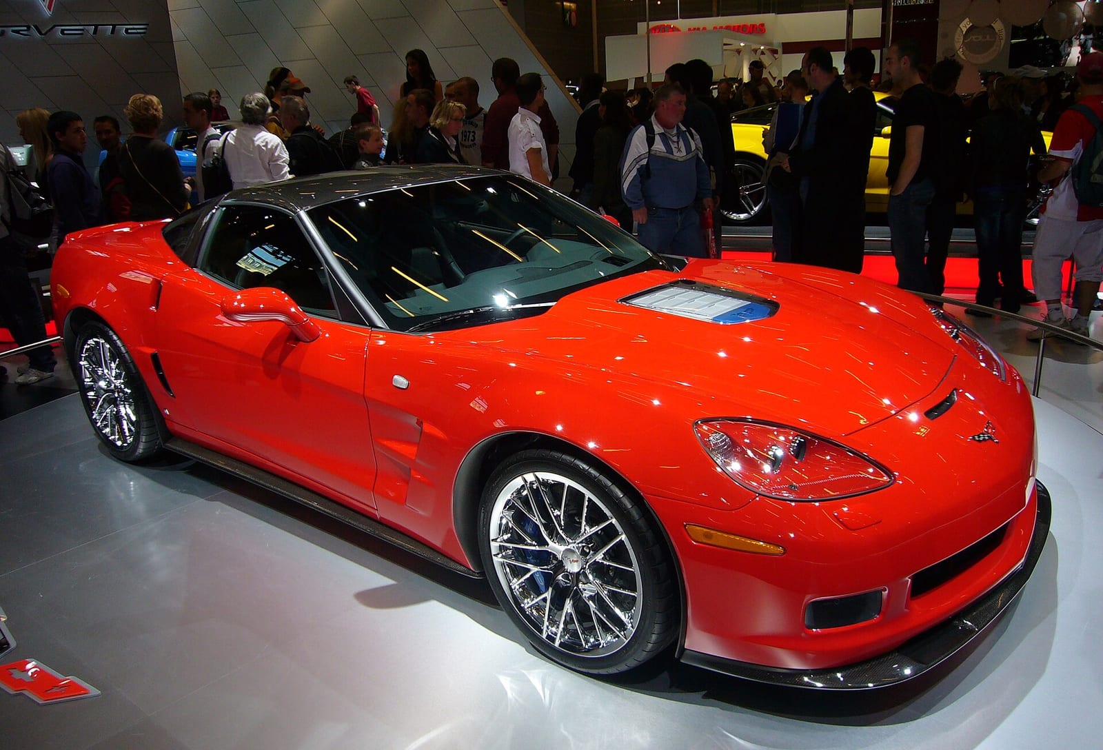 Red Chevrolet Corvette C6 ZR1 on a motor show stand