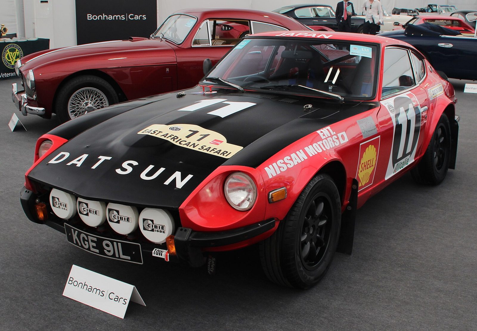 A red and black Datsun 240Z rally car in East African Safari Rally livery