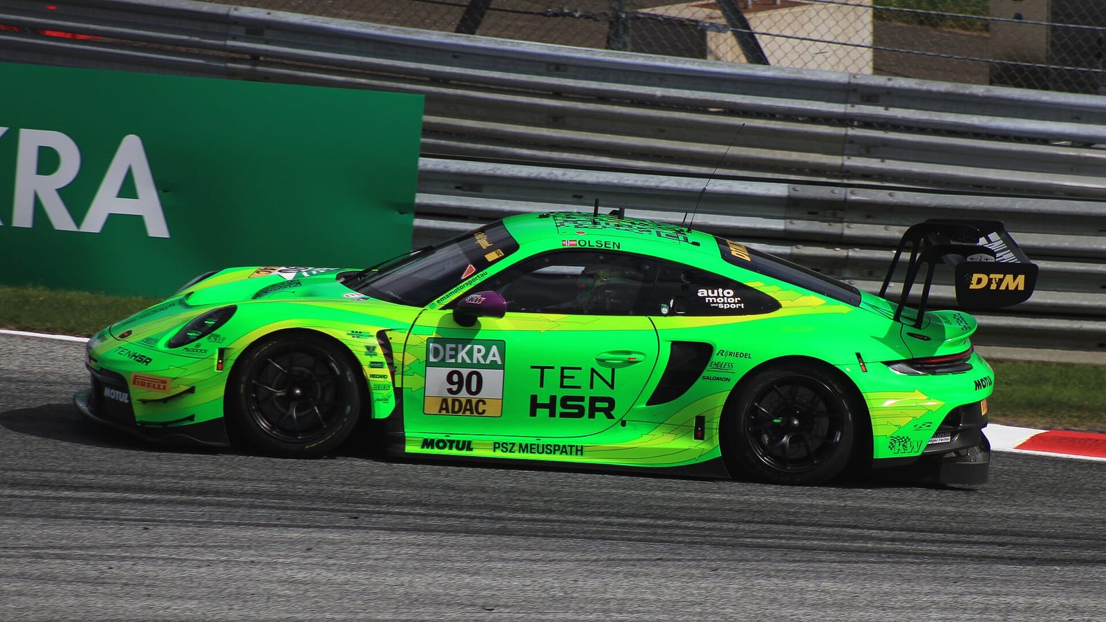 Green Porsche 911 GT3 R number 90 on track at Spielberg in the 2023 DTM