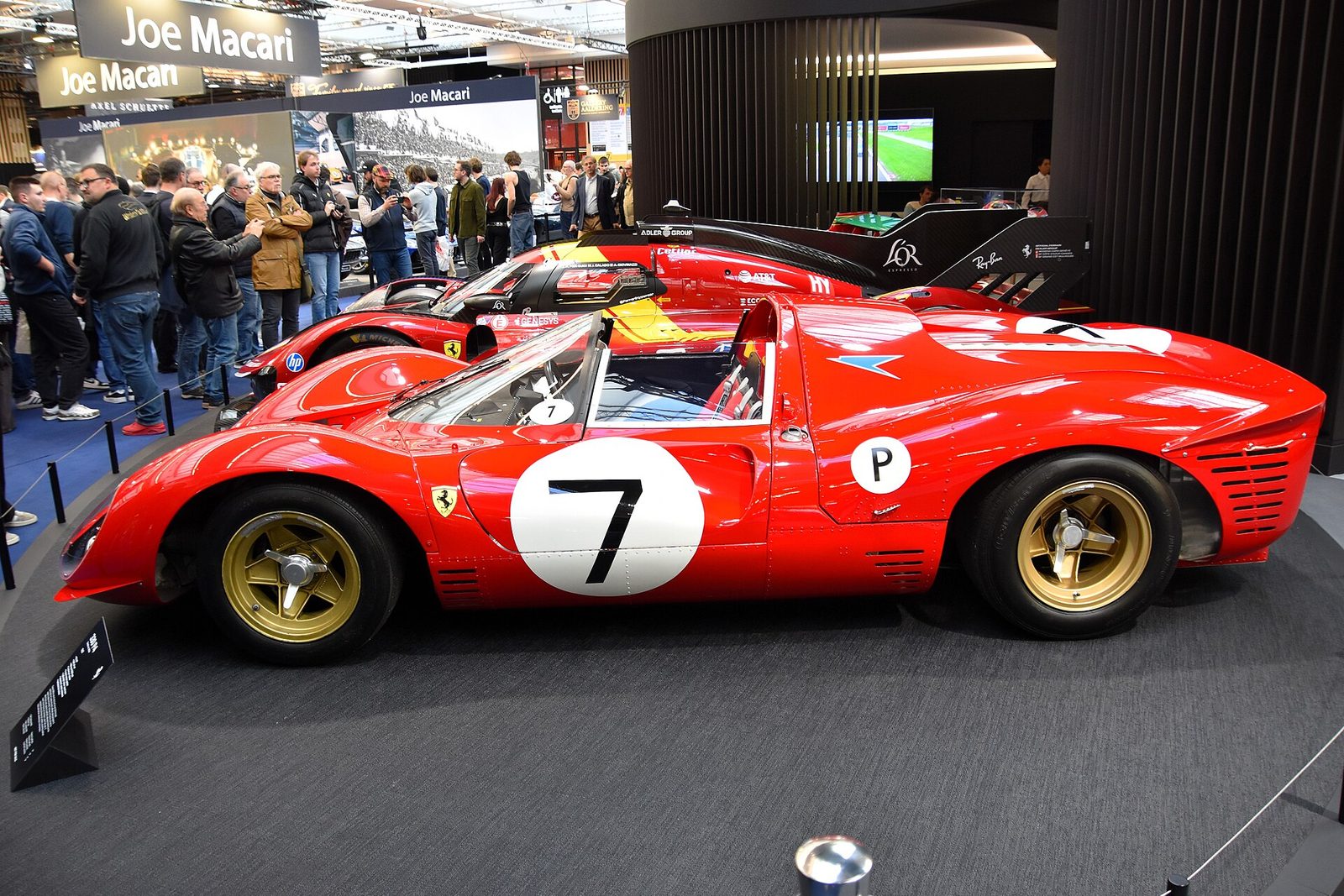 A red Ferrari 330 P4 with the number 7 on display at an indoor show