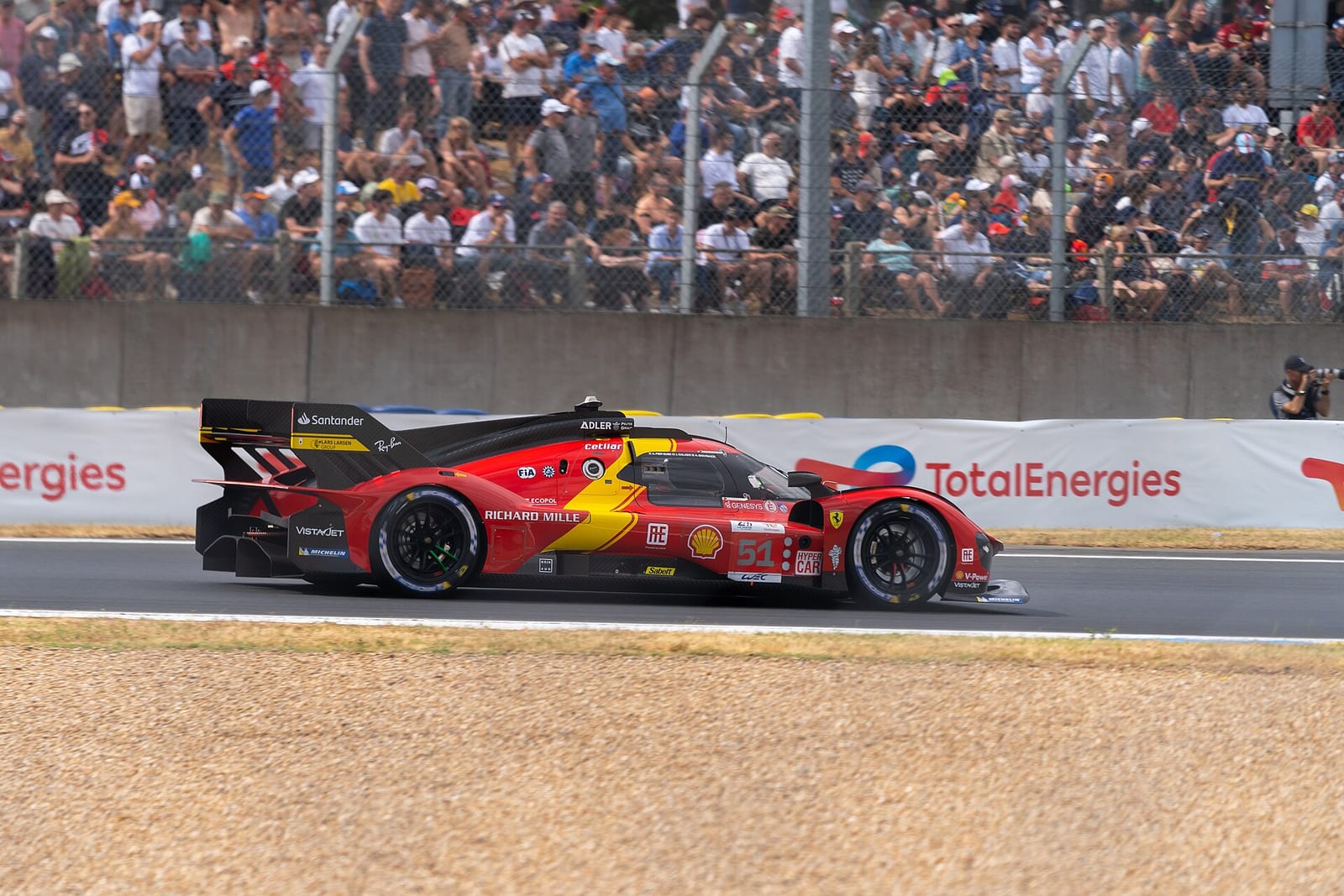 The number 51 Ferrari 499P passing the grandstands at the 2023 24 Hours of Le Mans