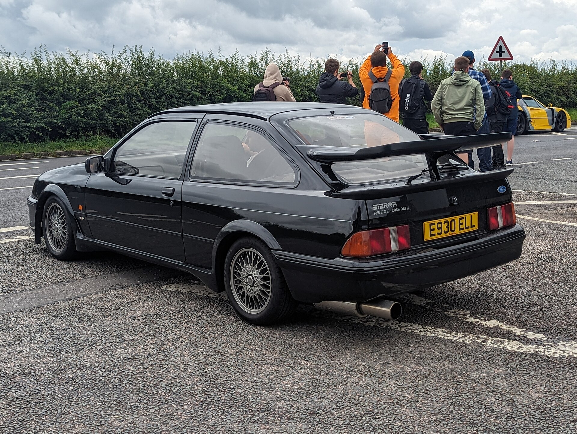 A black Ford Sierra RS500 Cosworth on a car park