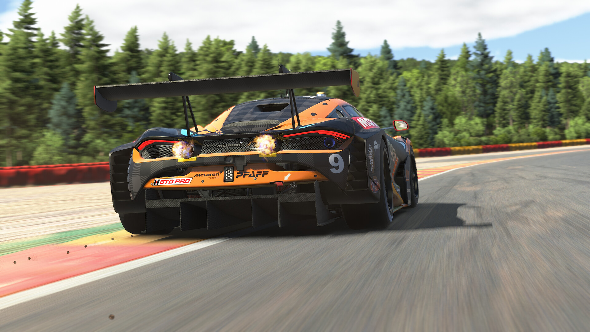 A GT3 car exits a corner over the kerb at speed in iRacing
