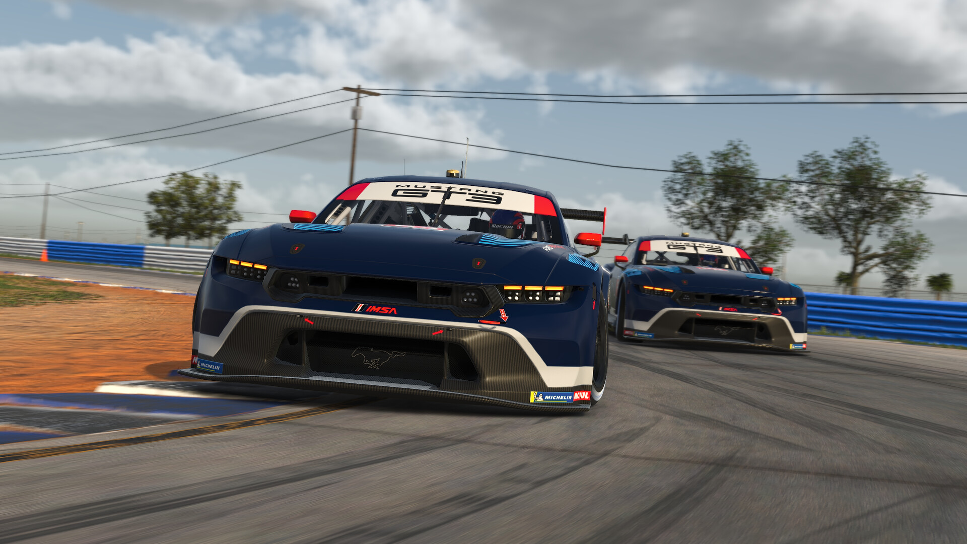 Two blue Ford Mustang GT3 cars nose to tail through a corner in iRacing