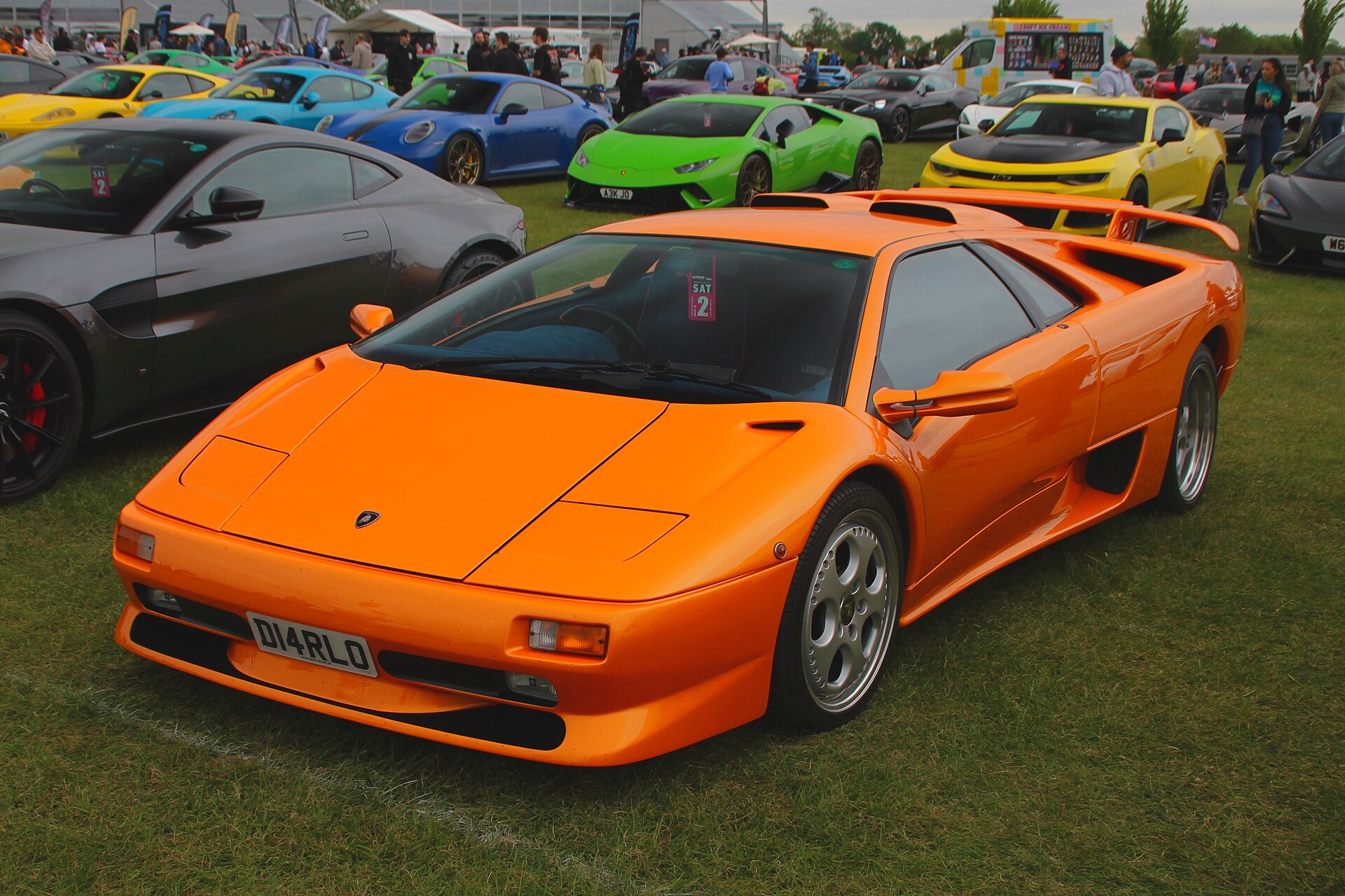 An orange Lamborghini Diablo SV at a car show