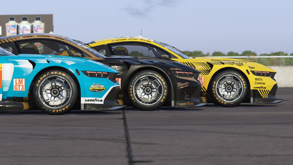 Two LMGT3 cars side by side through a corner in Le Mans Ultimate