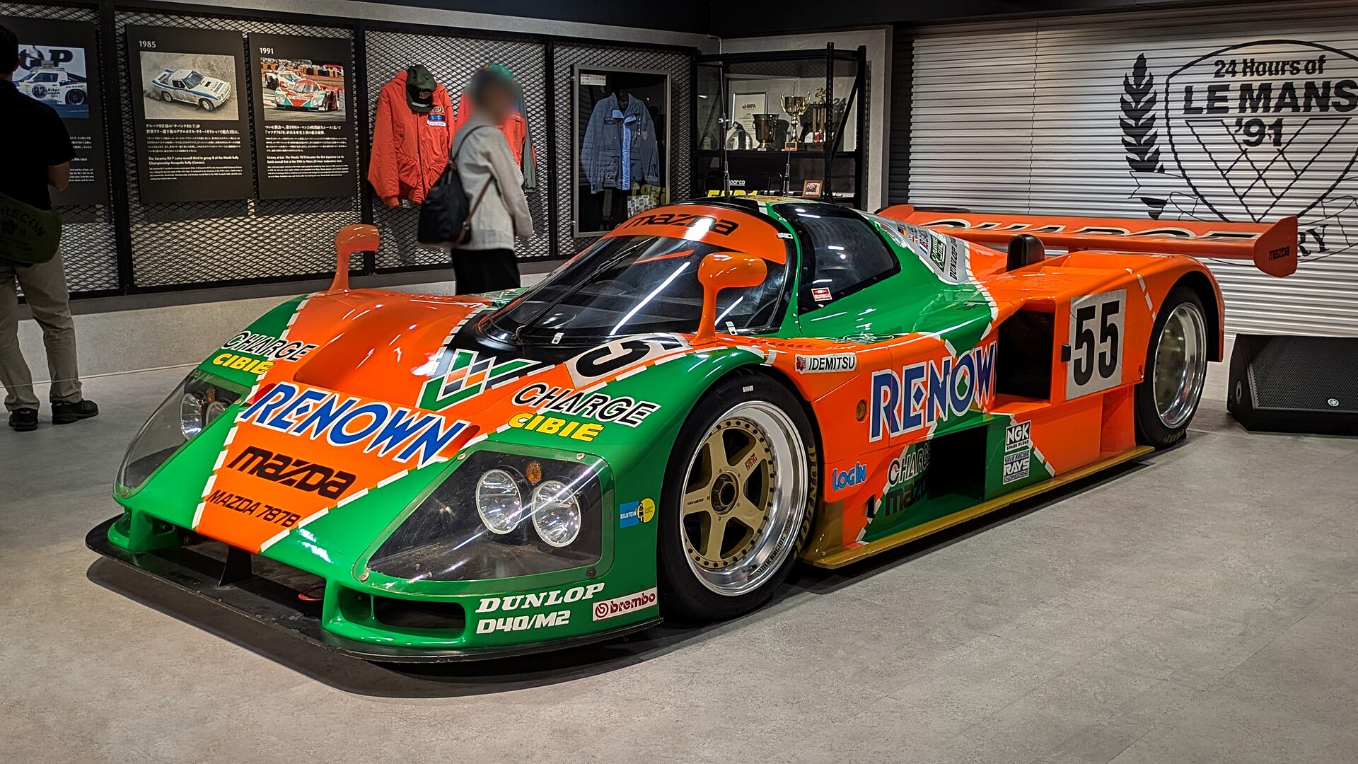 The orange and green Mazda 787B number 55 in the Mazda Museum