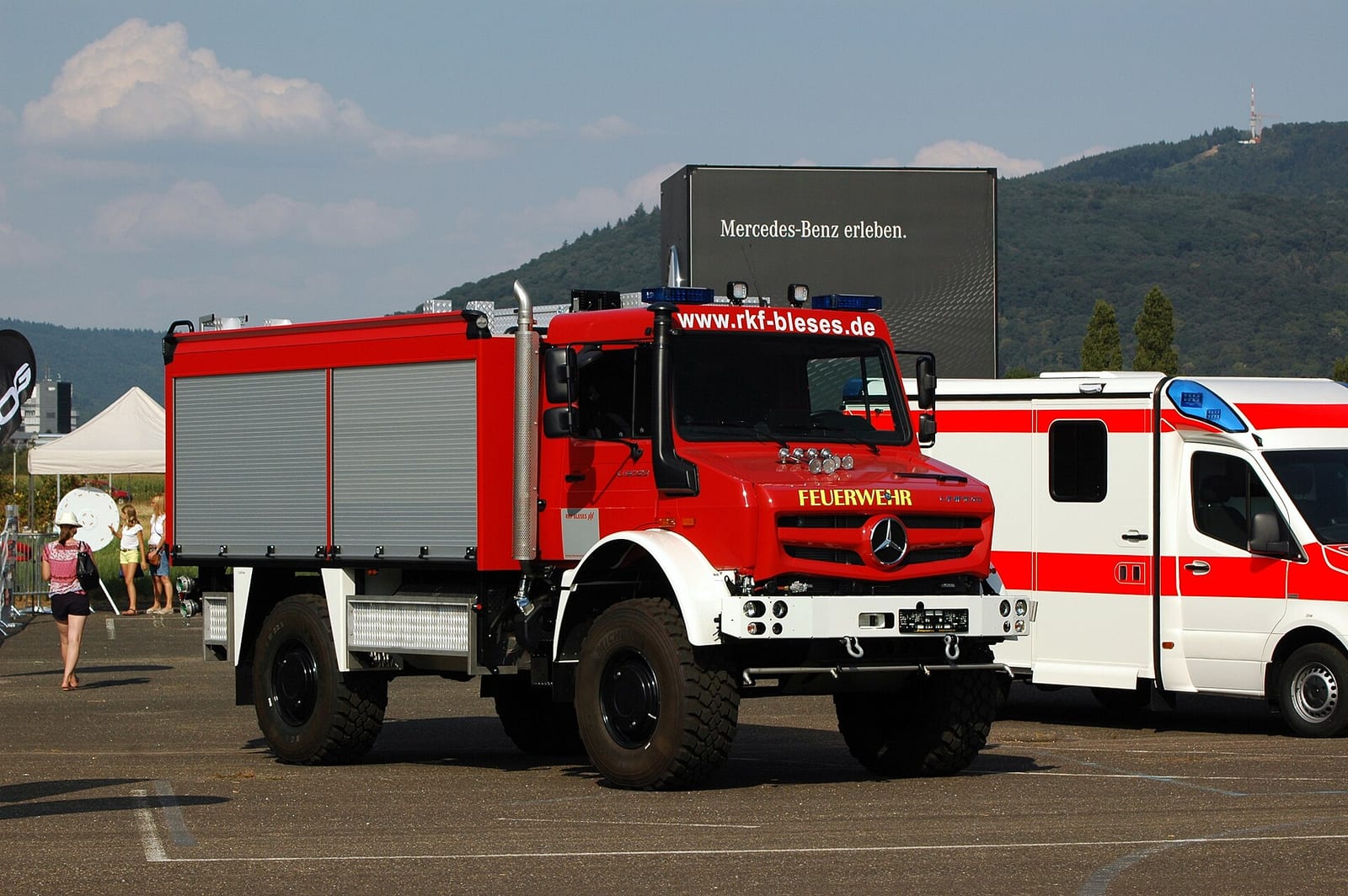 A red Mercedes-Benz Unimog U5023 fire service truck parked at Heidelberg Airfield