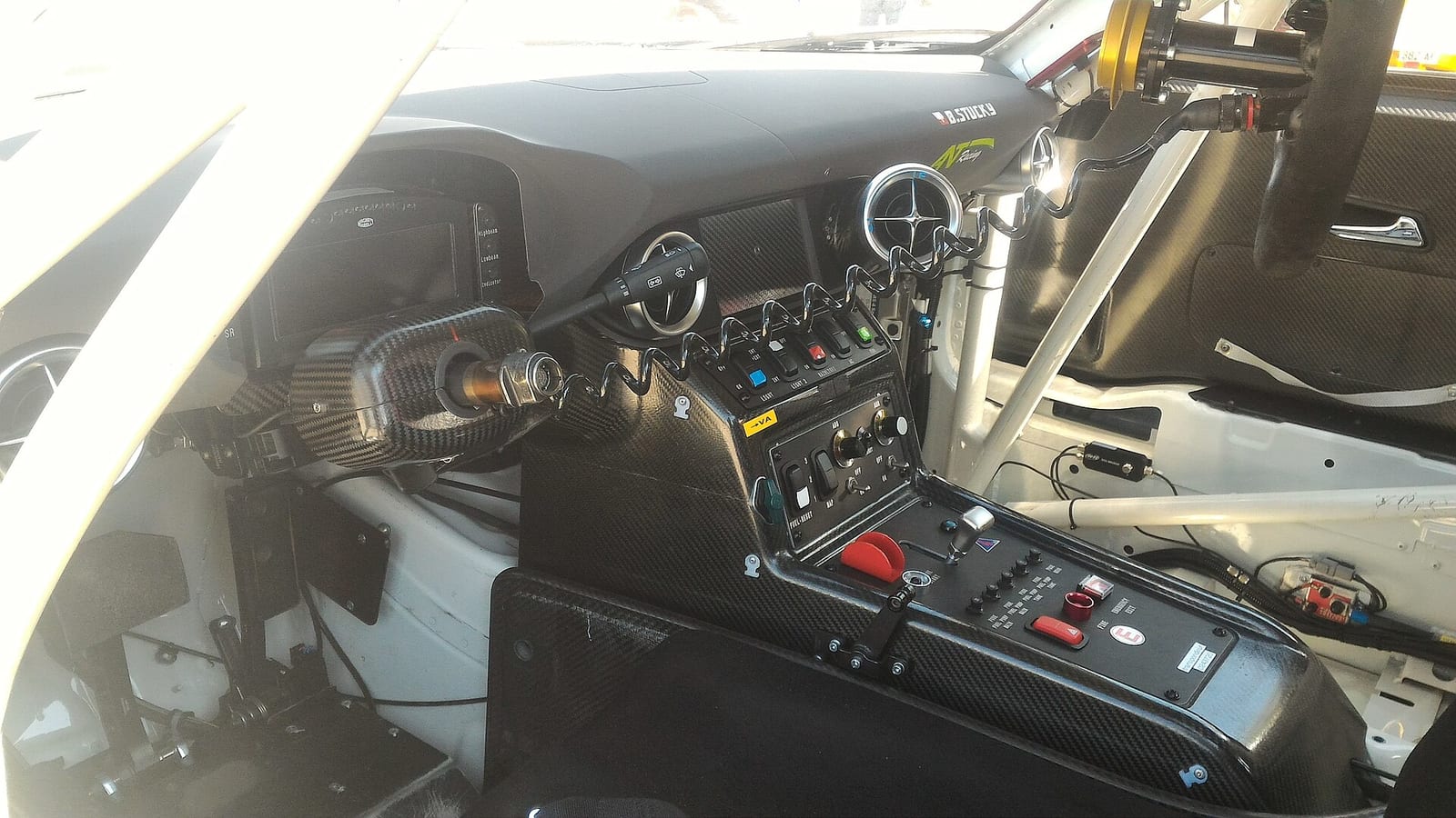 The centre console of a Mercedes SLS AMG GT3 race car with its switches and buttons