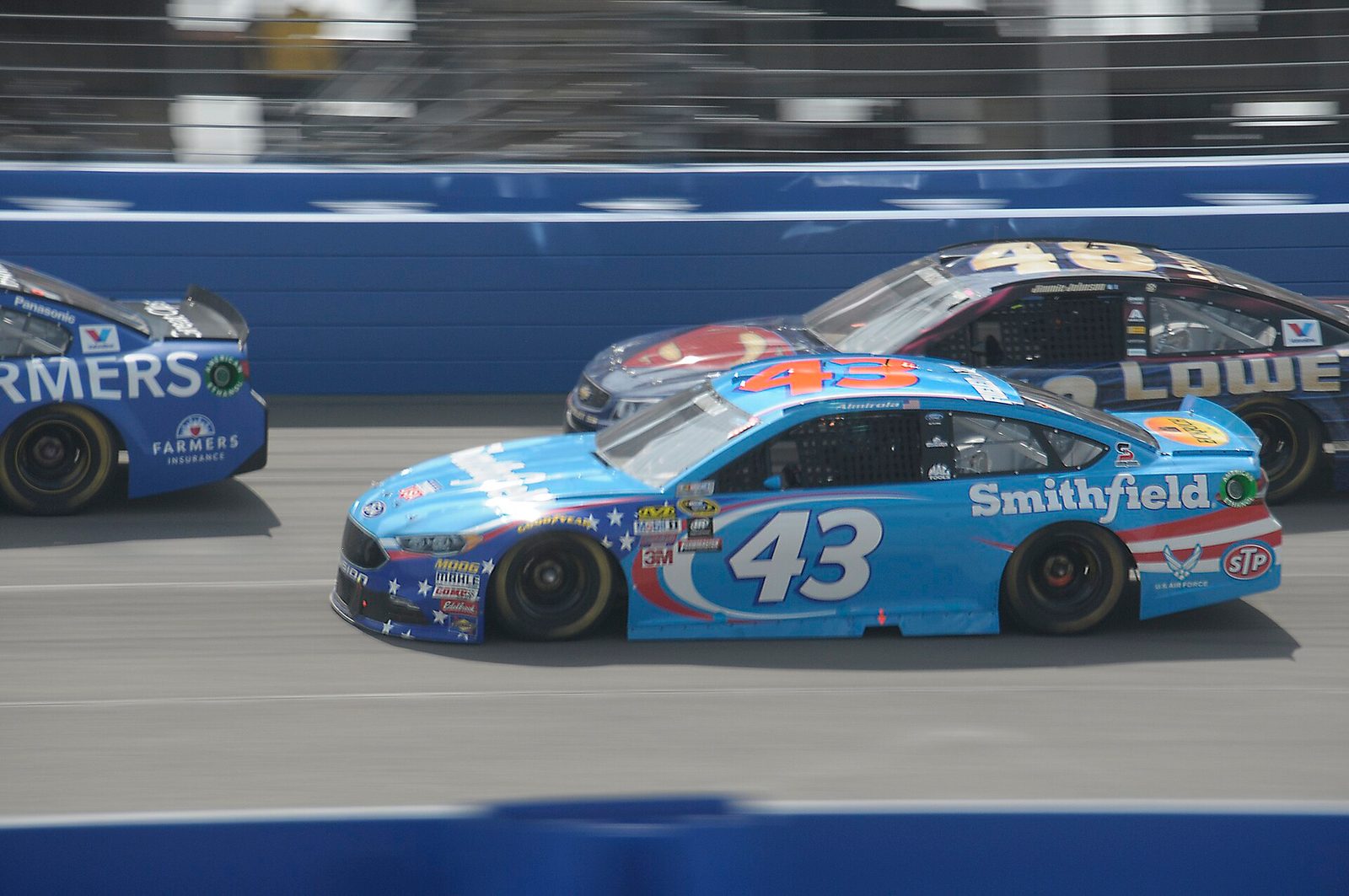 Aric Almirola's number 43 Ford and Jimmie Johnson's number 48 Chevrolet side by side at Auto Club Speedway in 2016