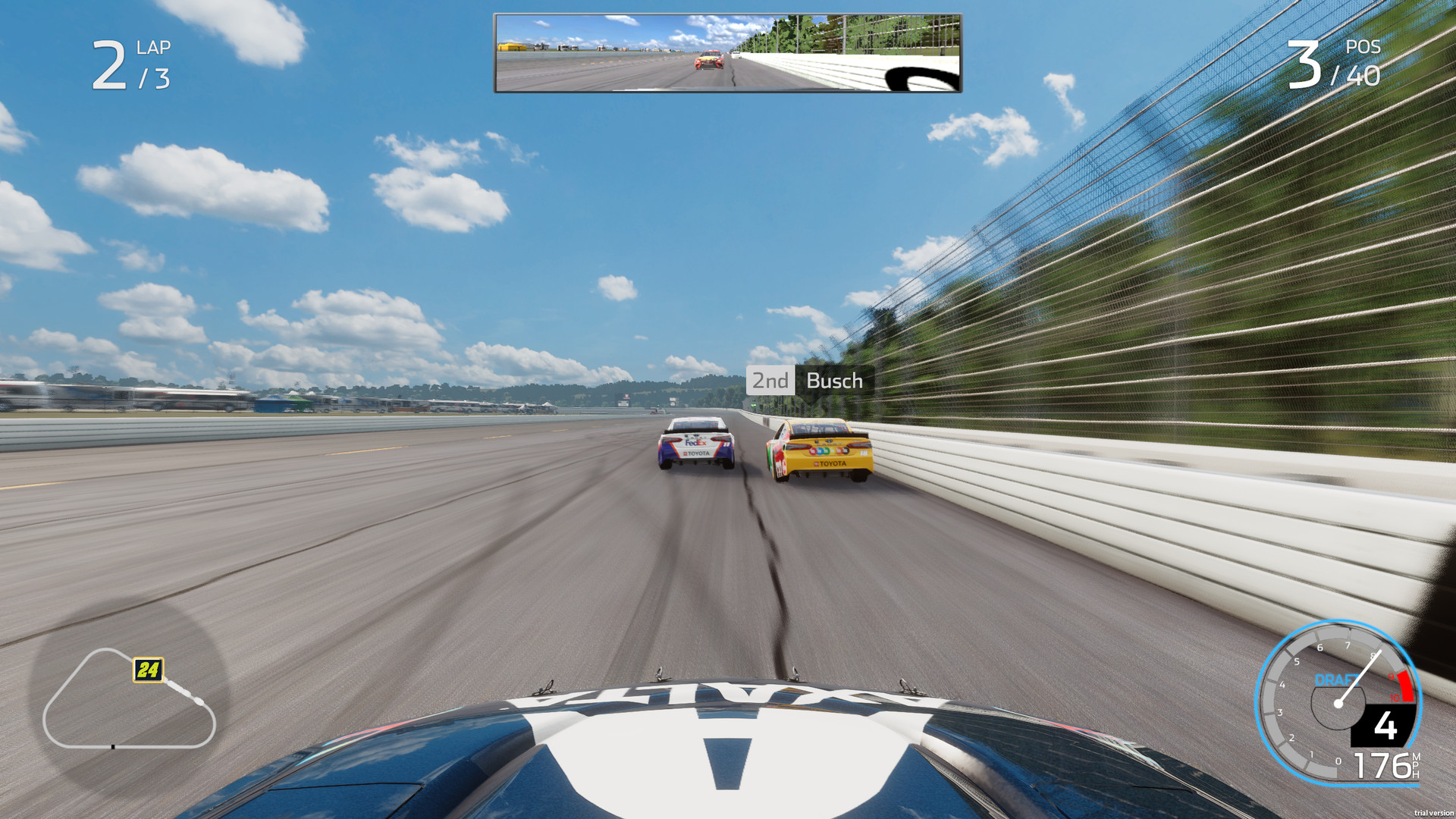 A NASCAR Cup car on the high line of a paved oval in NASCAR Heat 5, seen from the bumper camera with two cars ahead