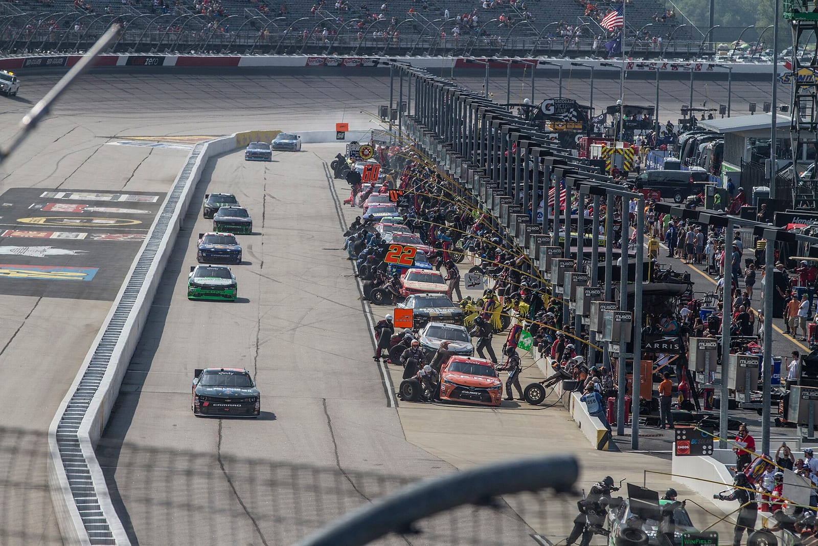 Stock cars lined up for pit stops on pit road at Darlington Raceway