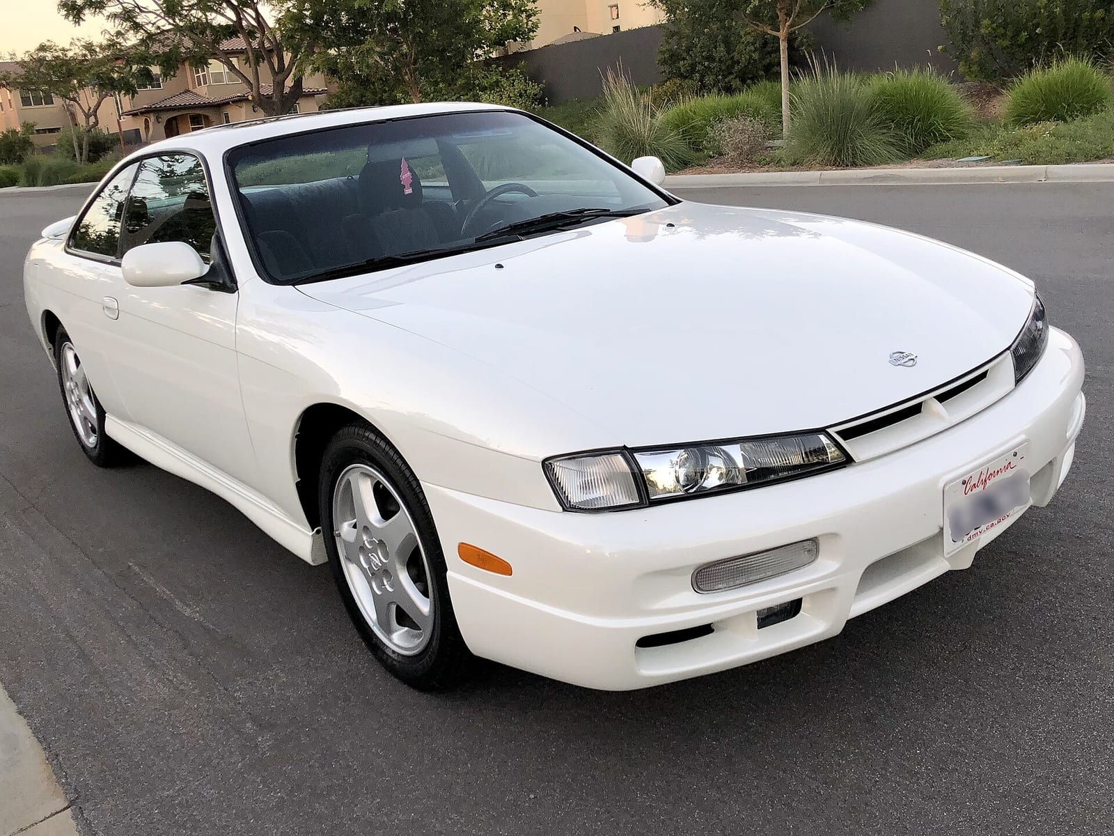A white 1997 Nissan 240SX (S14), front three quarter view