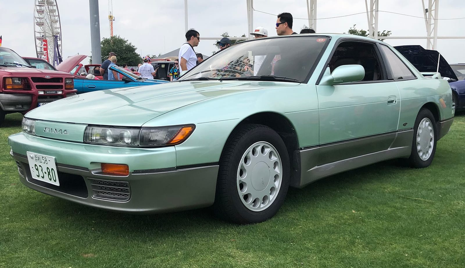 A green Nissan Silvia K's (S13) at a car show