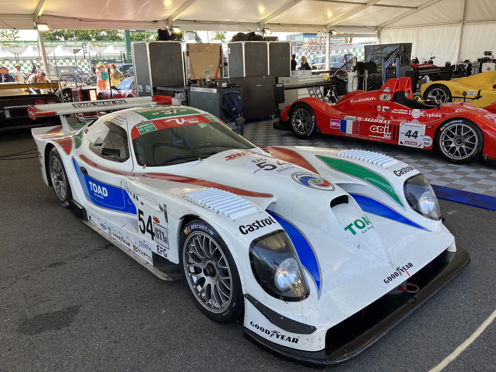 The white number 54 Panoz Esperante GTR-1 in the paddock at the 2022 Le Mans Classic