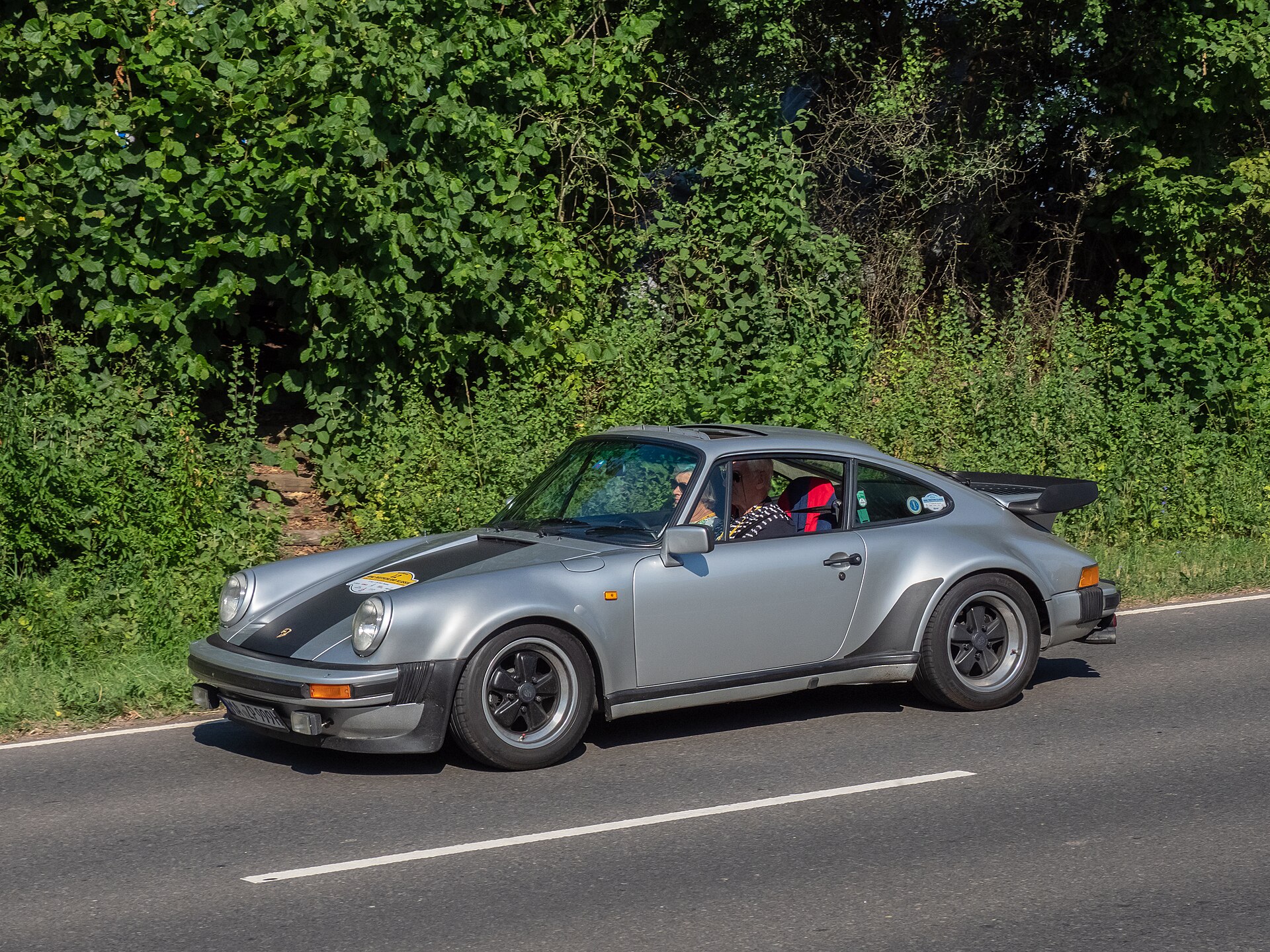 A silver Porsche 911 Turbo 3.3 on a road