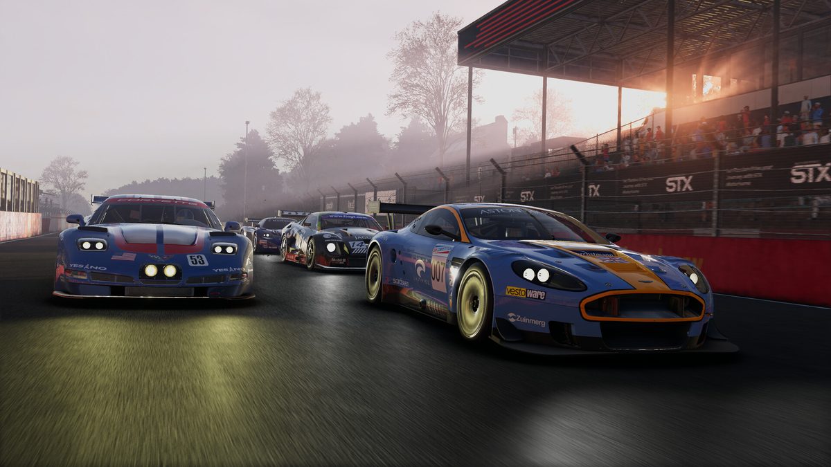 An Aston Martin DBR9 and a Chevrolet Corvette C5.R side by side at sunrise in the GT class of Project Motor Racing