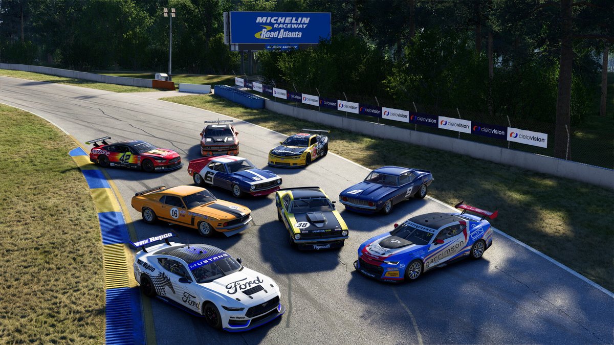 The nine cars of the Project Motor Racing V8 Power Pack parked together at Road Atlanta