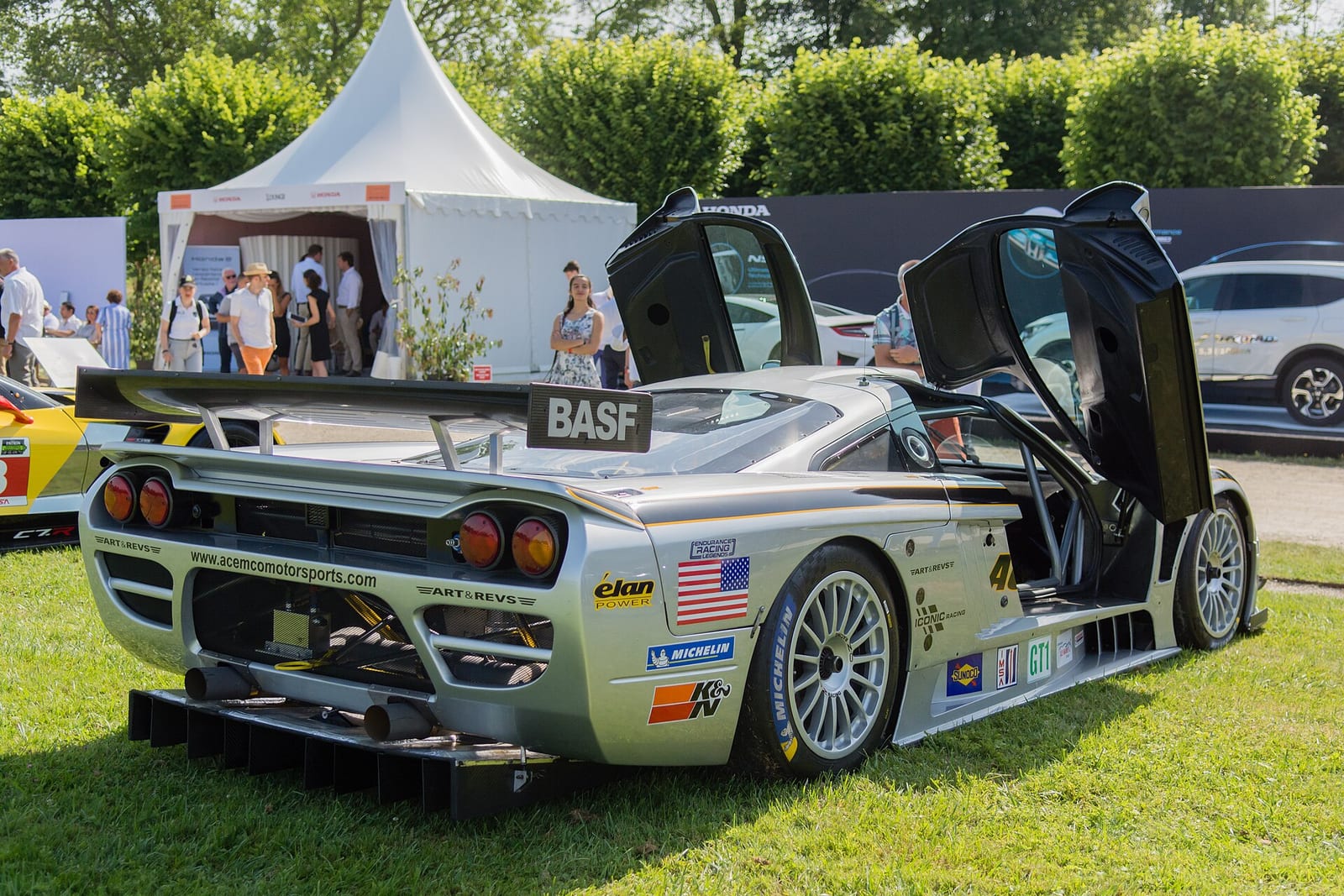 A silver Saleen S7R GT1 race car from behind with its doors open