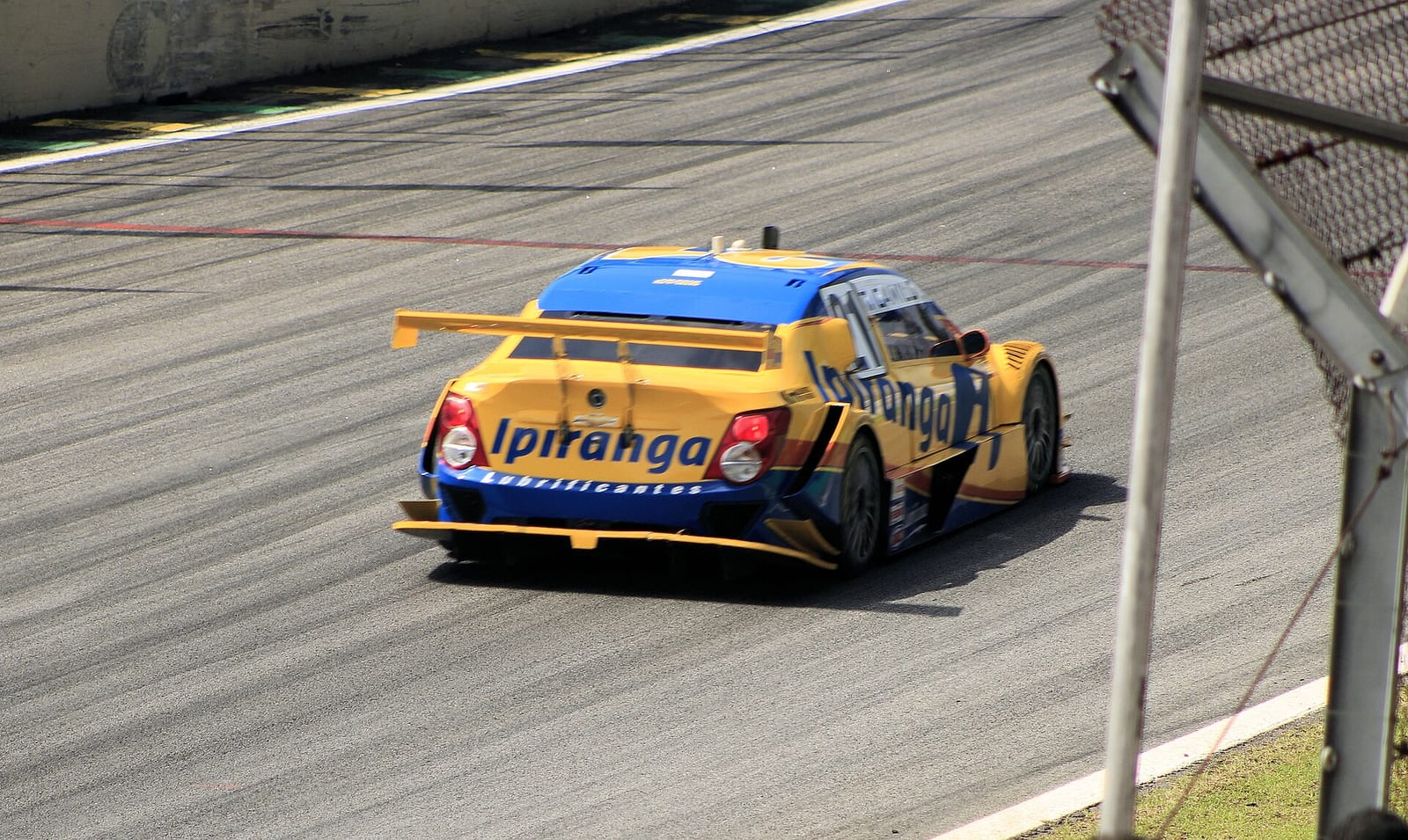 A Stock Car Brasil car seen from behind going through a corner at Interlagos