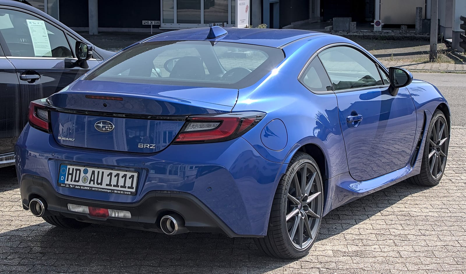 A blue second generation Subaru BRZ, rear three quarter view