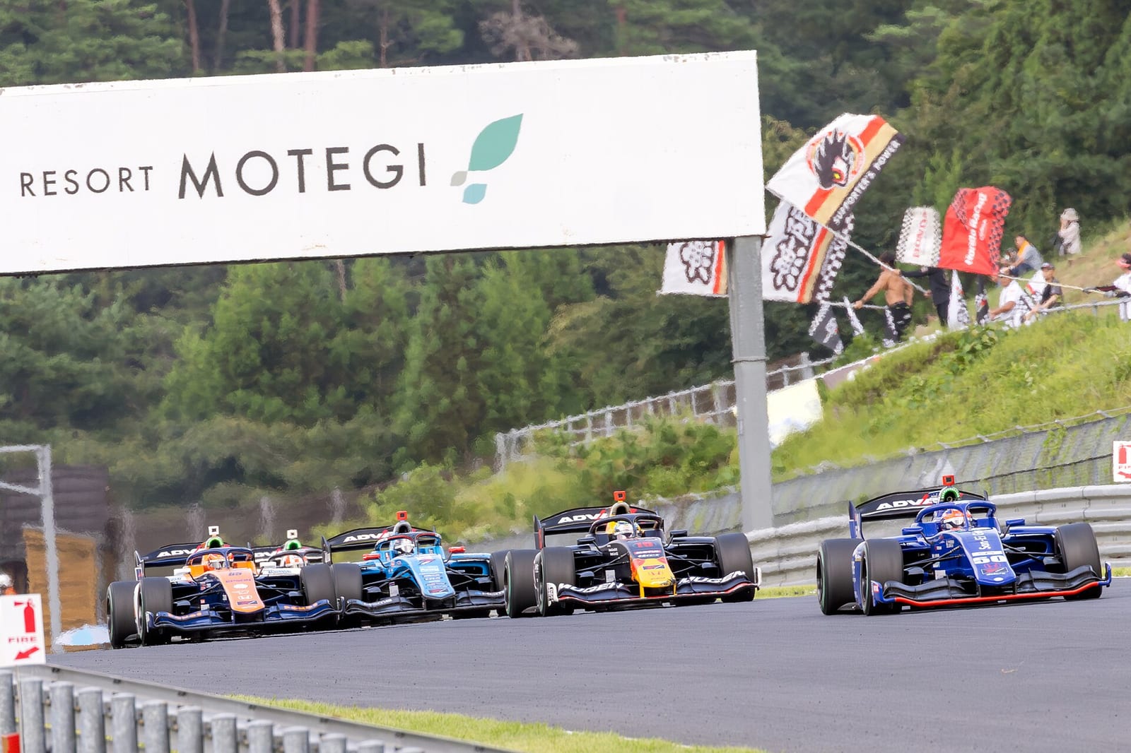 Super Formula cars on the opening lap at Motegi in 2024