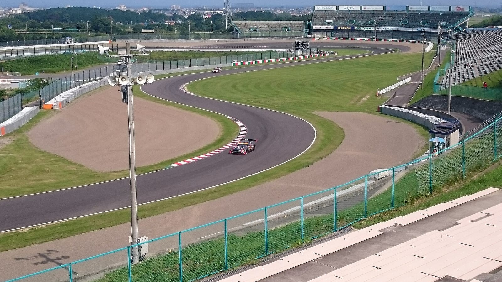 View over the S curves at Suzuka Circuit with a race car on track