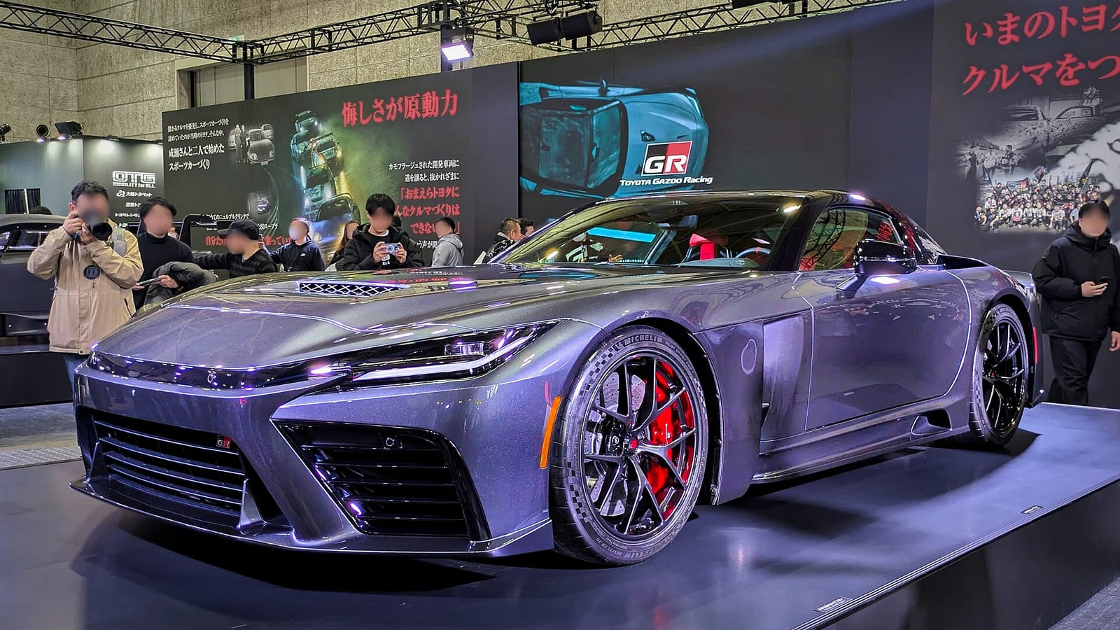 The Toyota GR GT Prototype on a show stand, front three quarter view