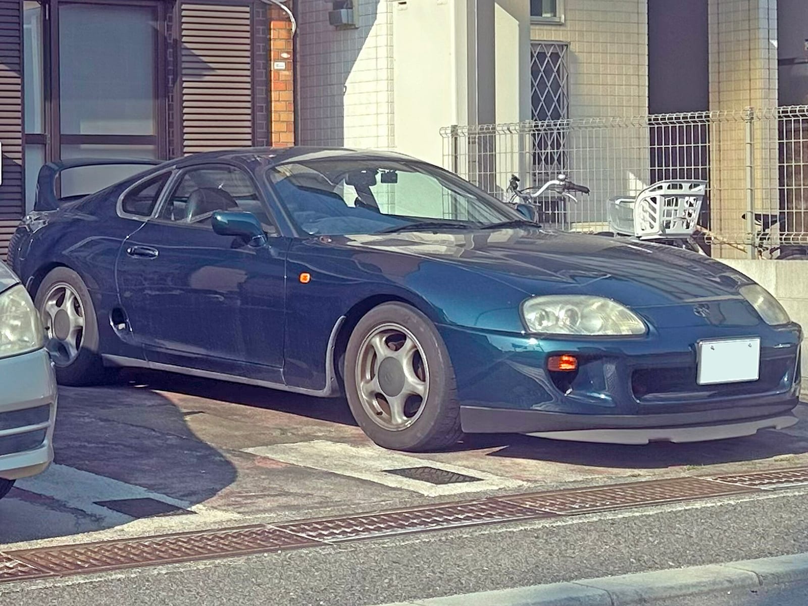 A dark green Toyota Supra RZ parked in Japan