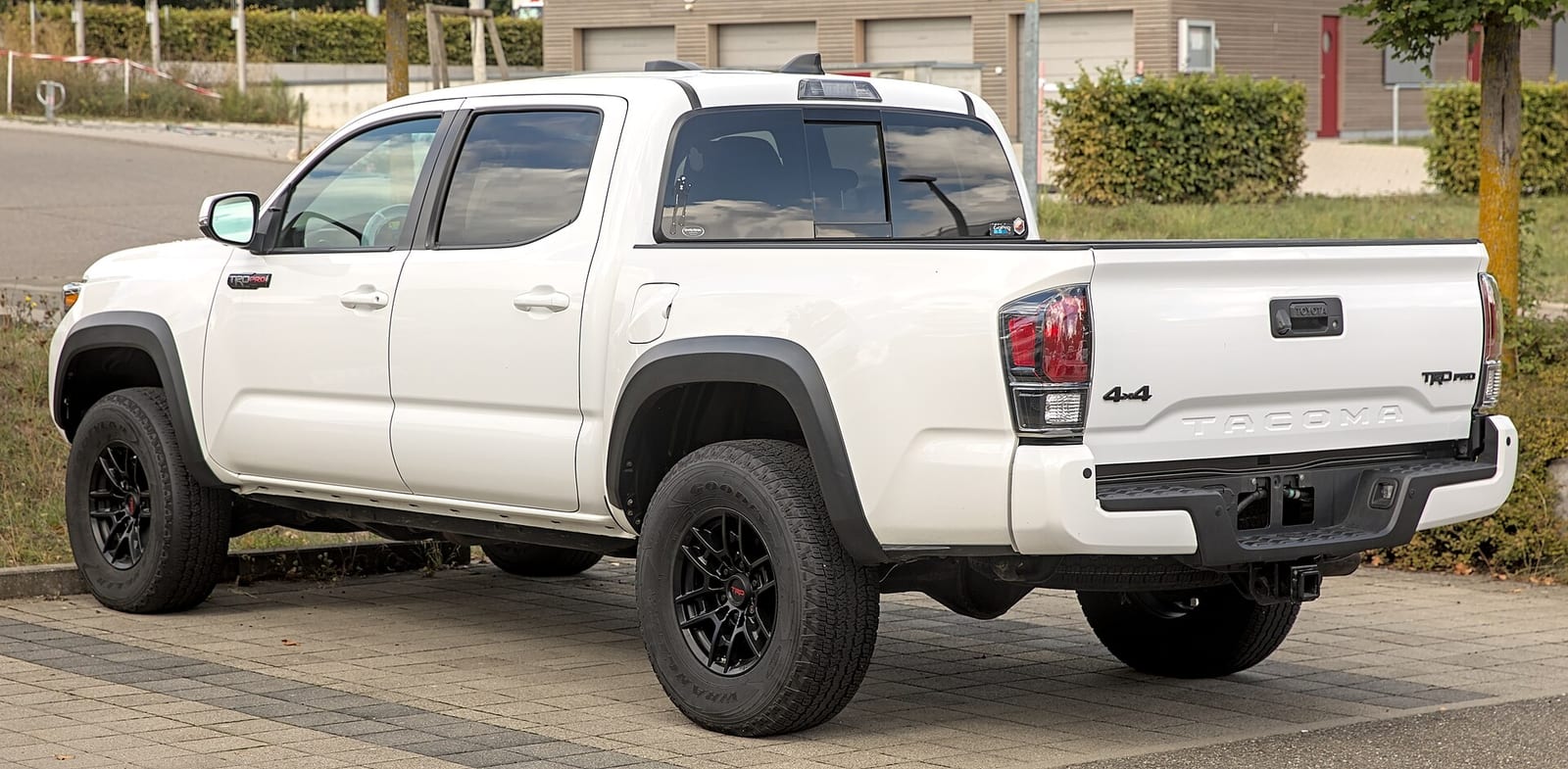 A white Toyota Tacoma TRD Pro pickup, rear three quarter view