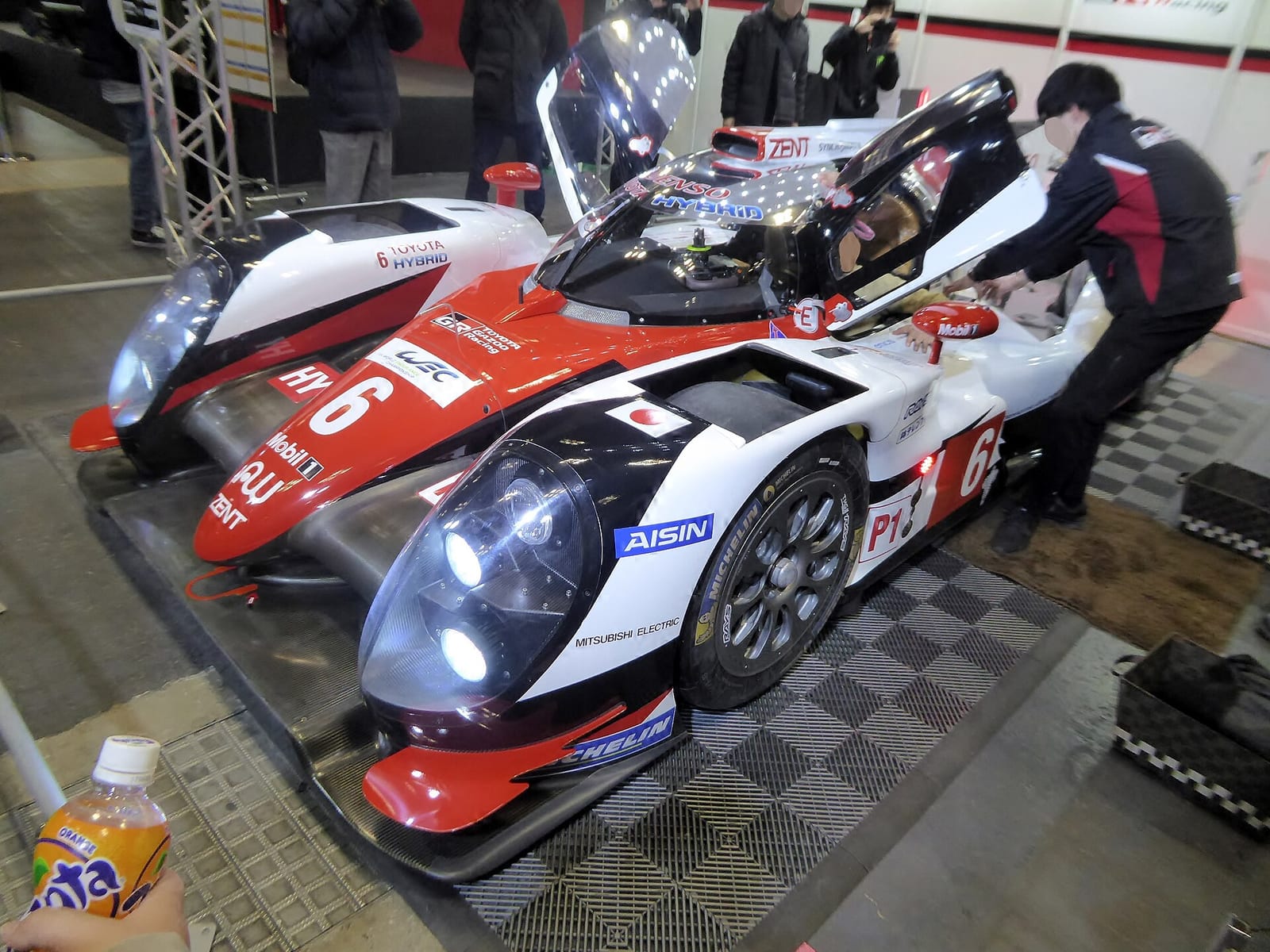 A Toyota TS050 Hybrid in red and white Toyota Gazoo Racing colours on display at Osaka Auto Messe 2017