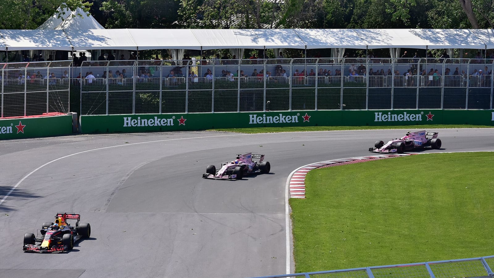 A Red Bull ahead of the two pink Force India cars in the 2017 Canadian Grand Prix