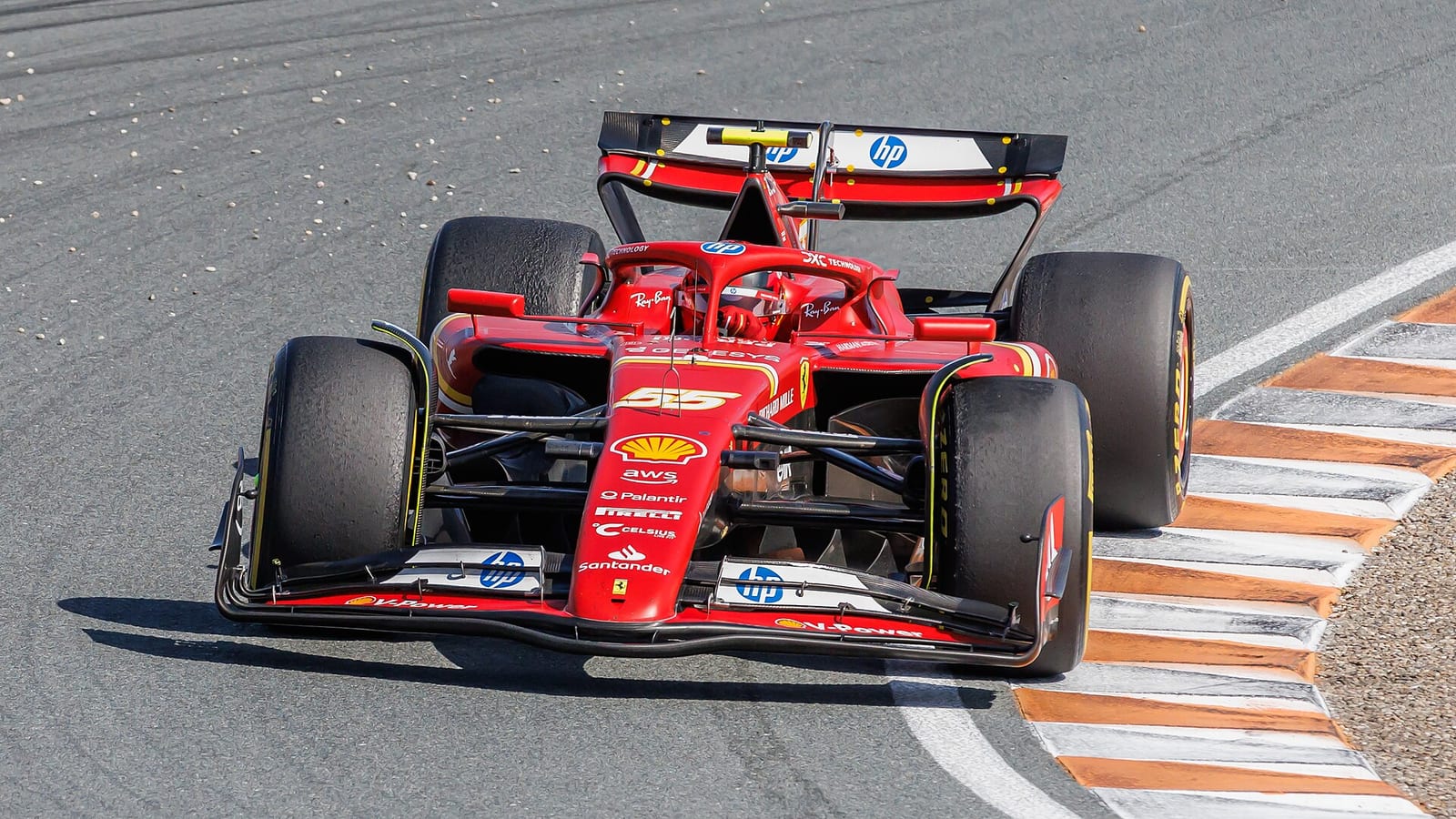 Carlos Sainz's Ferrari SF-24, number 55, head on over a kerb at Zandvoort during the 2024 Dutch Grand Prix