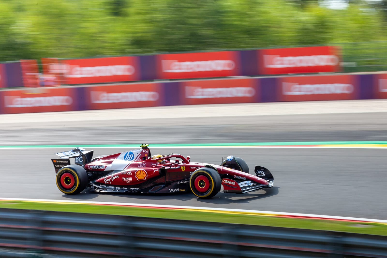 Lewis Hamilton's Ferrari SF-25 in a one off livery, side on at speed at Spa-Francorchamps during the 2025 Belgian Grand Prix weekend