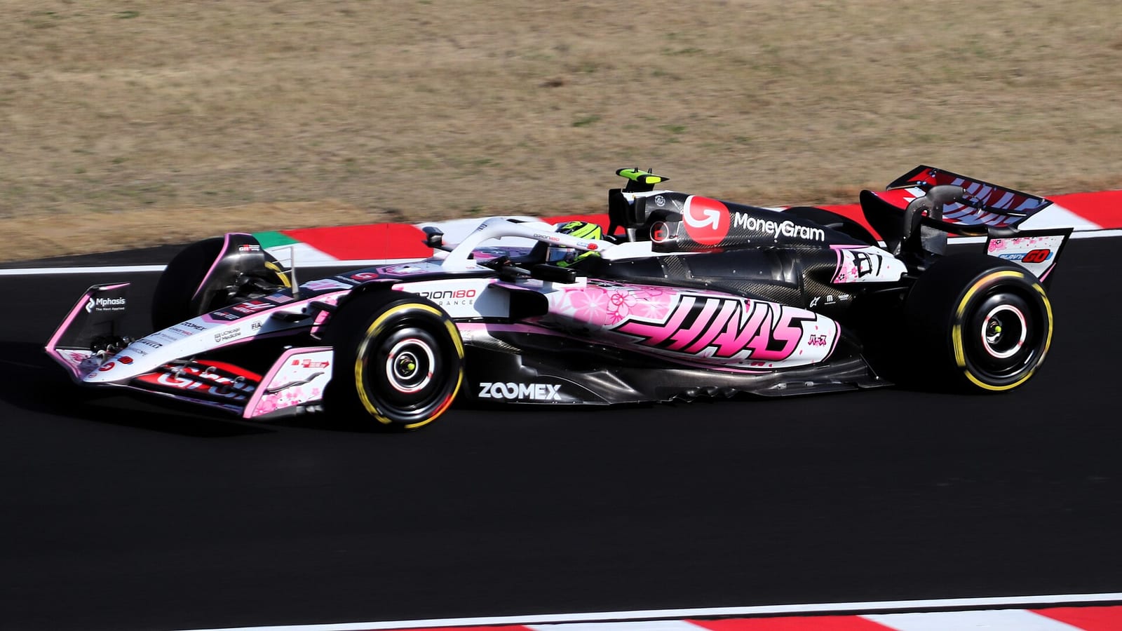 Oliver Bearman in the Haas VF-25 with its pink cherry blossom livery on track at Suzuka during second practice for the 2025 Japanese Grand Prix