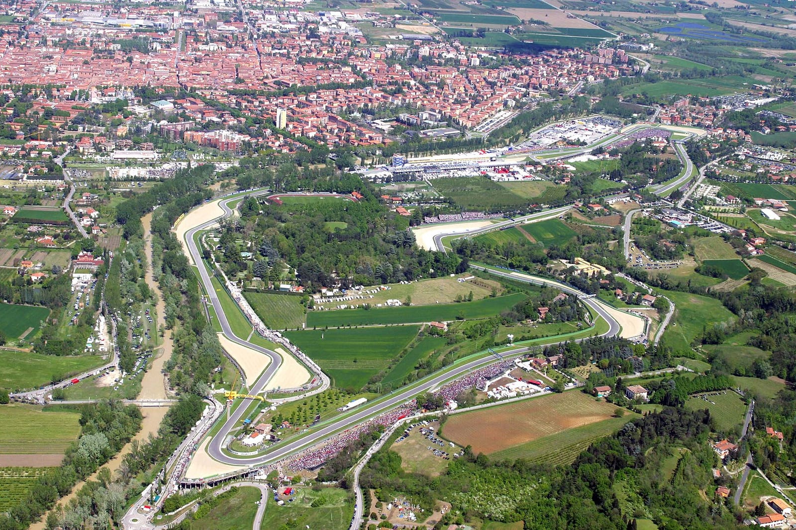 Aerial photo of the Imola circuit with the town behind it and the Santerno river running along the left side of the track