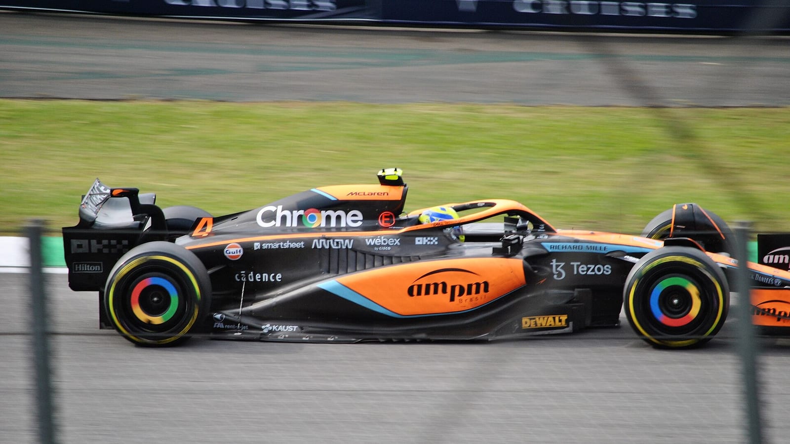 Lando Norris's orange and blue McLaren MCL36 seen from the side at speed at Interlagos during the 2022 São Paulo Grand Prix weekend