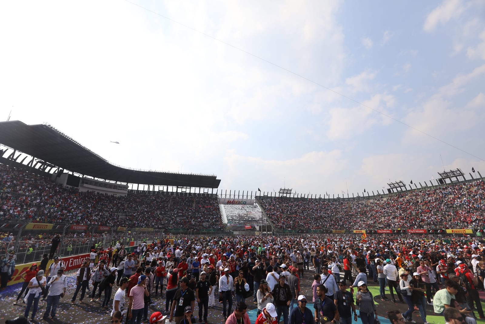 The crowd on the track in front of the stadium grandstands after the 2017 Mexican Grand Prix