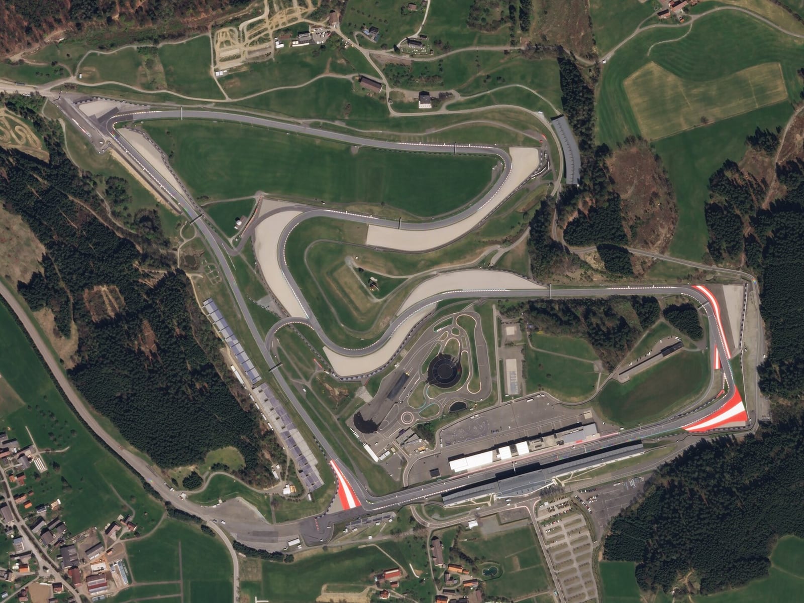 Satellite view of the Red Bull Ring in Spielberg showing the main straight at the bottom and the climb to turn 3 at the top left