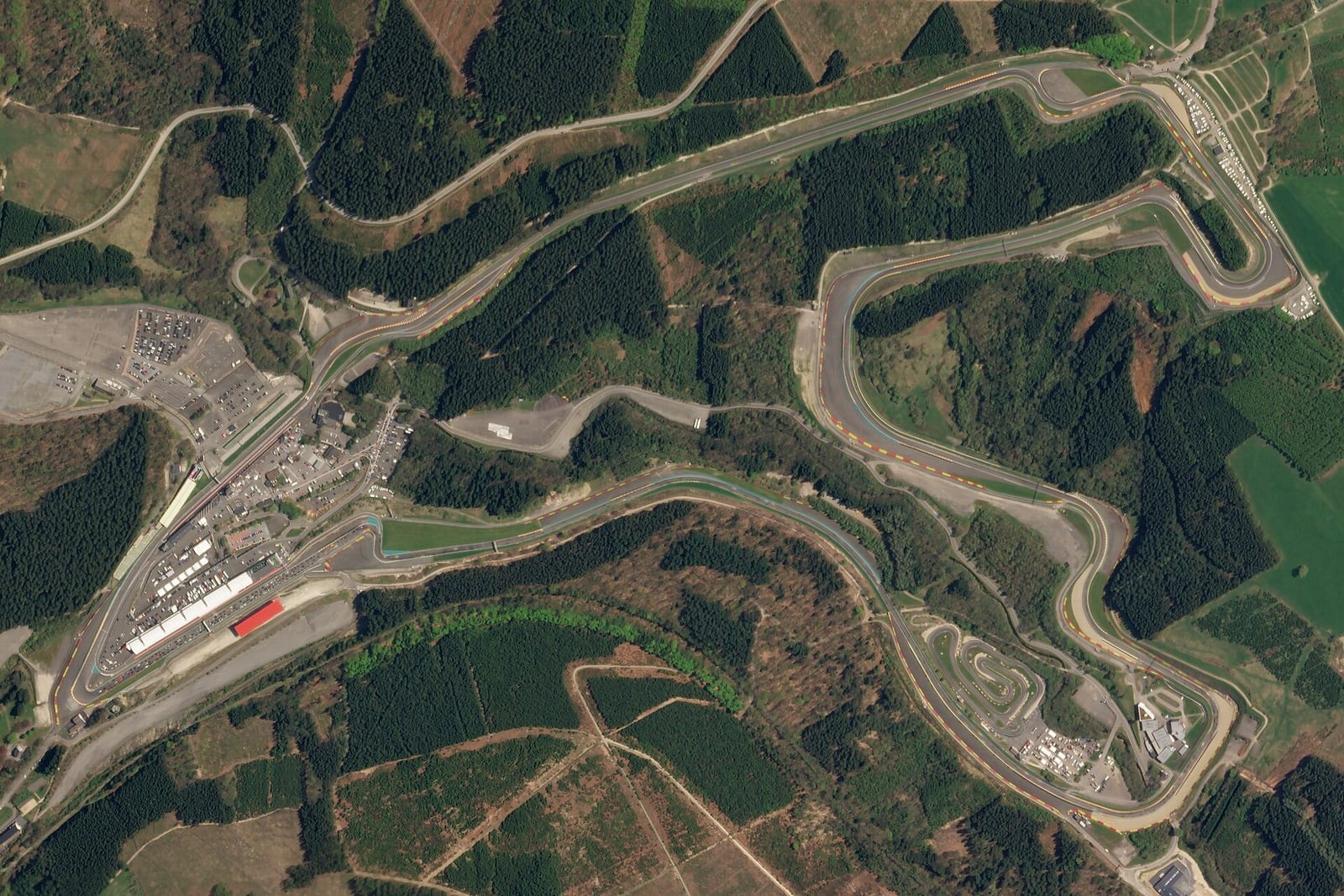 Satellite view of the Circuit de Spa-Francorchamps in the Ardennes forest, showing the full lap and the pit complex