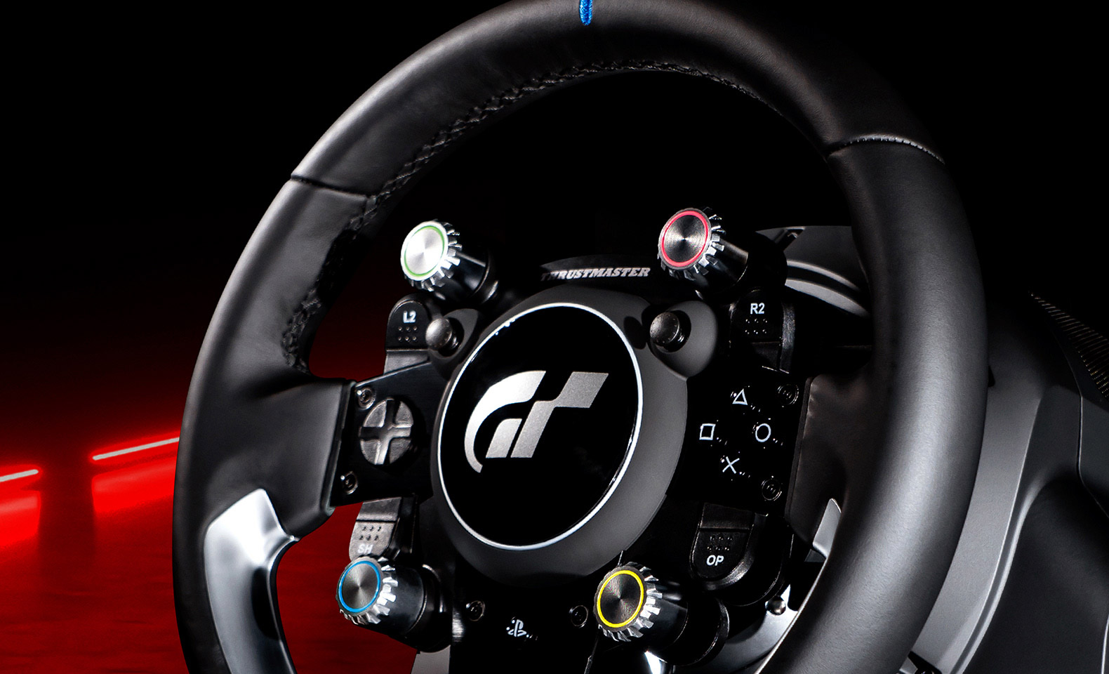 The Thrustmaster T-GT II rim with the Gran Turismo logo on the hub and four coloured rotary selectors