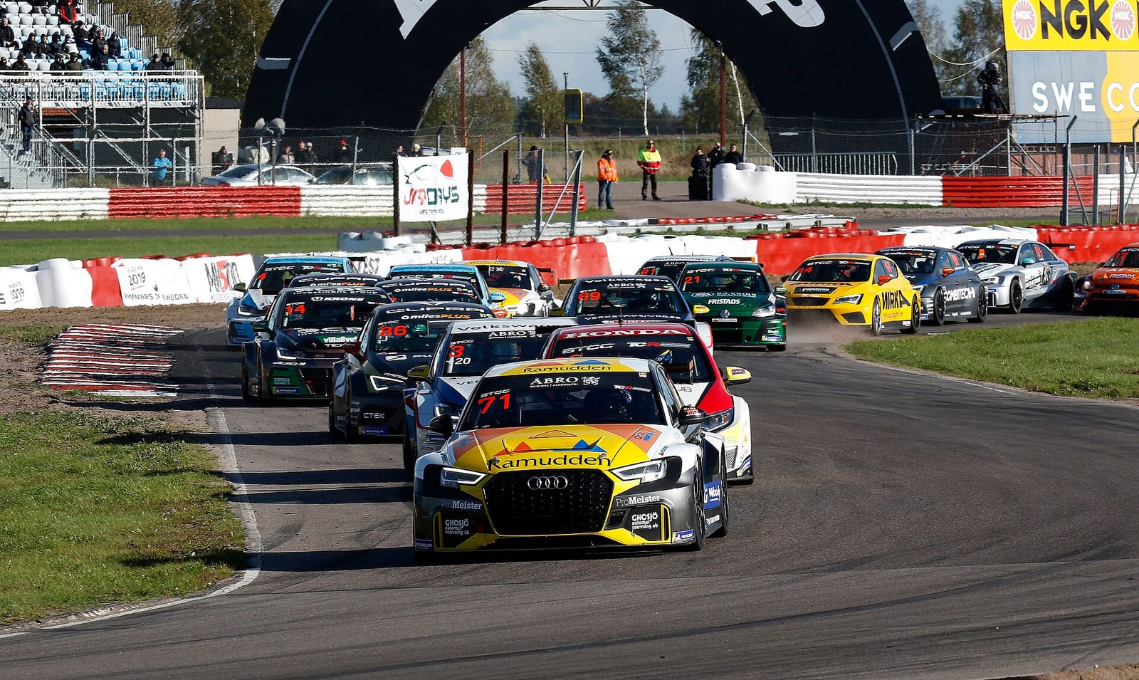 Touring cars in a line through a corner at Mantorp Park during the 2018 STCC final