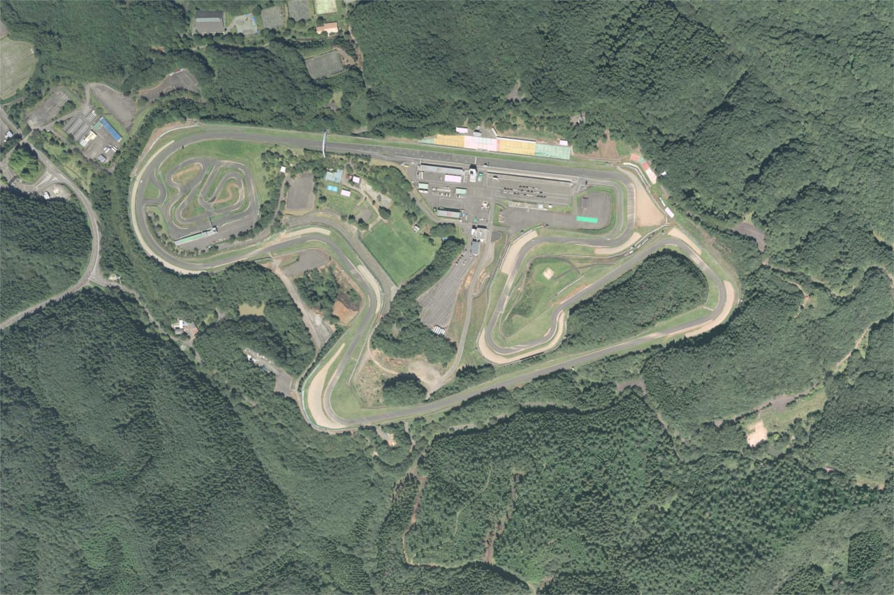 Aerial photo of Sportsland SUGO showing the road course on a wooded hillside